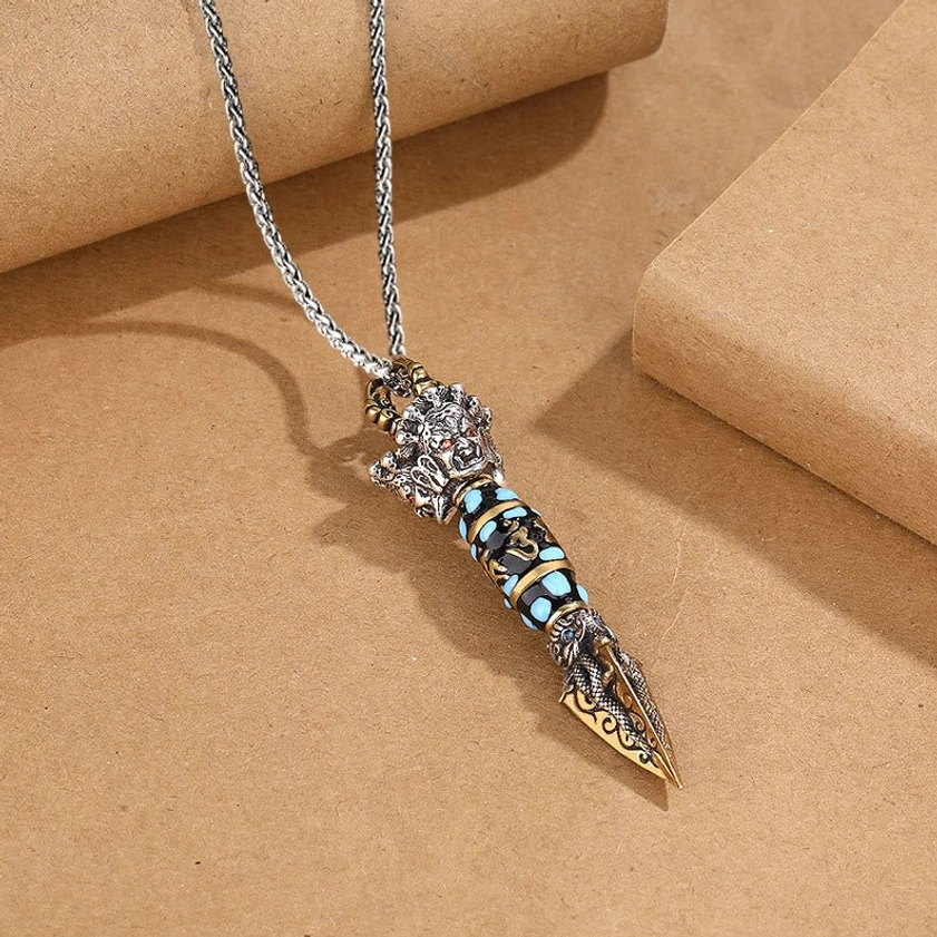 Sacred Buddhist Dorje Vajra dzi bead pendant necklace, side angle view highlighting three-dimensional dragon carving and spiritual craftsmanship