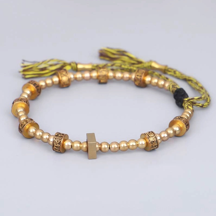 Buddhist Om Mani Padme Hum bracelet flat lay with square metal spacer and yellow tassel rope