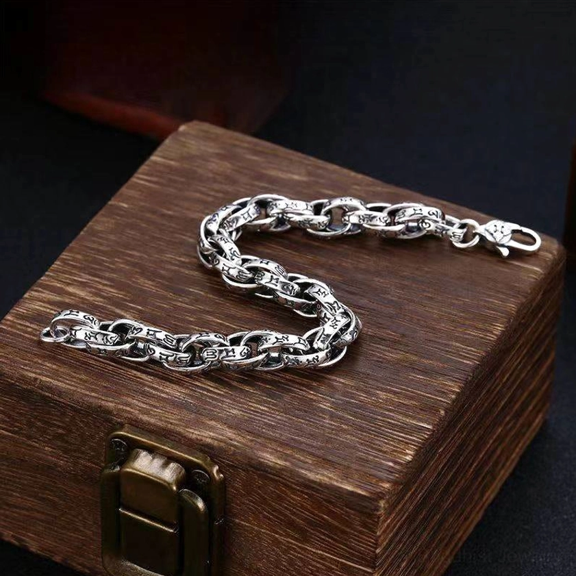 Extended view of six-syllable mantra bracelet showing full engraved chain length with antique copper finish