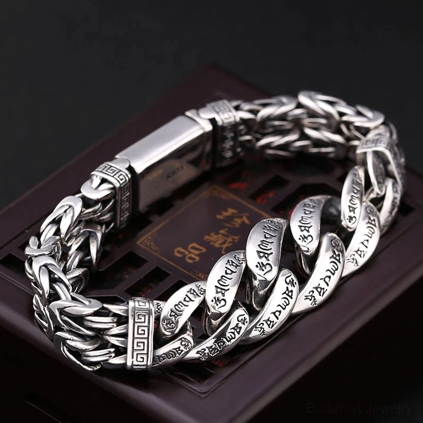 Buddhist spiritual bracelet side view displaying braided curb chain with engraved mantras and decorative clasp