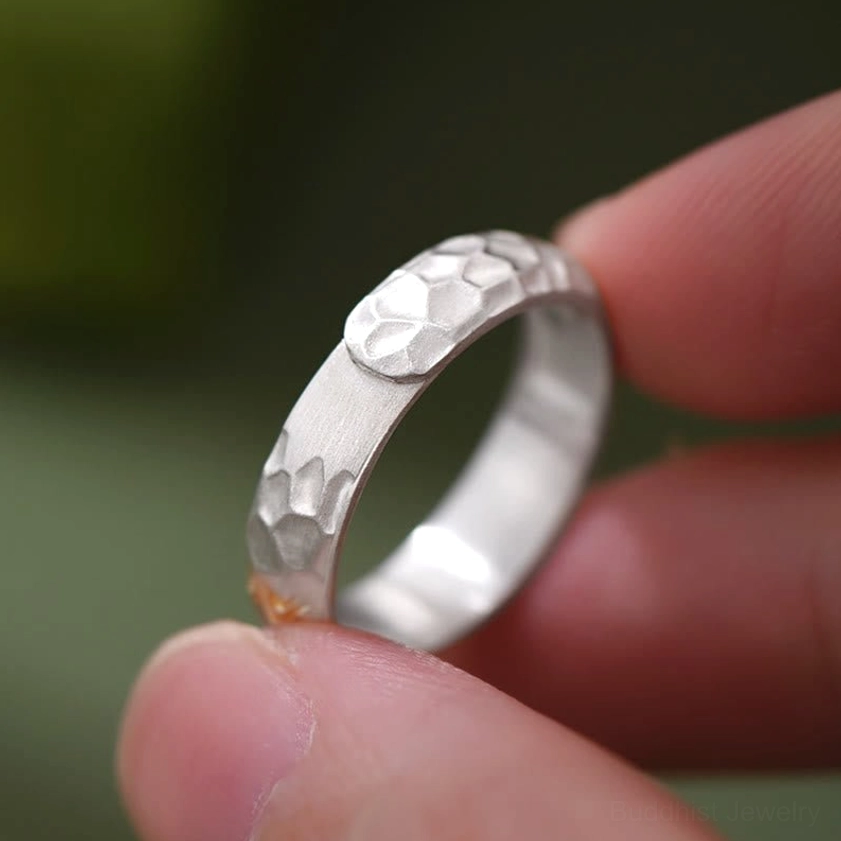 Sacred mantra ring detail shot emphasizing gold Sanskrit text clarity and artisan engraving quality