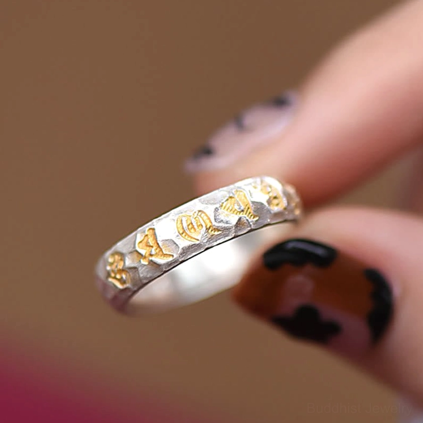 Sacred mantra ring macro photography showing hammered texture and copper silver metal composition