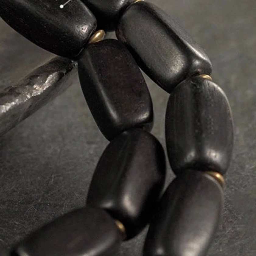 Ebony wood dzi bracelet with sacred nine-eye symbol for spiritual protection