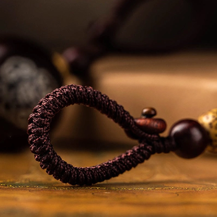 Sacred protective gourd keychain combining ebony and red sandalwood options, ideal gift for meditation and spiritual wellness