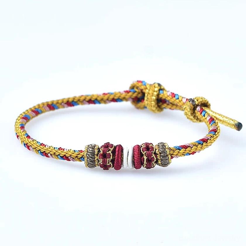 Buddhist red string bracelet with decorative knots sacred spiritual protection talisman