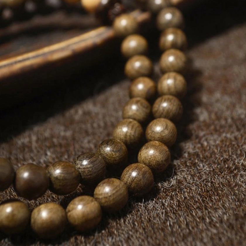Handcrafted sandalwood Buddhist prayer mala bracelet with smooth wooden beads, perfect for meditation practice and spiritual protection