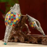 Handmade sacred shankha conch shell decoration with colorful circular enamel inlays and carved silver metal trim on display stand