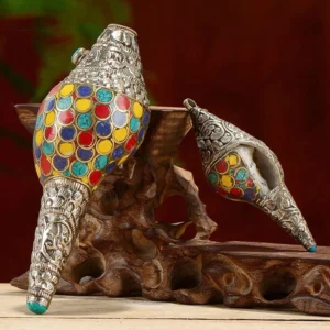 Handmade sacred shankha conch shell decoration with colorful circular enamel inlays and carved silver metal trim on display stand