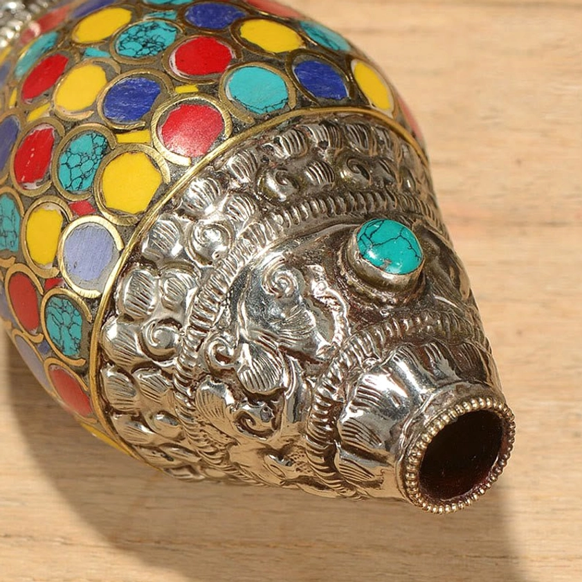 Sacred conch shell shankha ornament featuring traditional enamel inlays symbolizing Buddhist mandala and cosmic wholeness