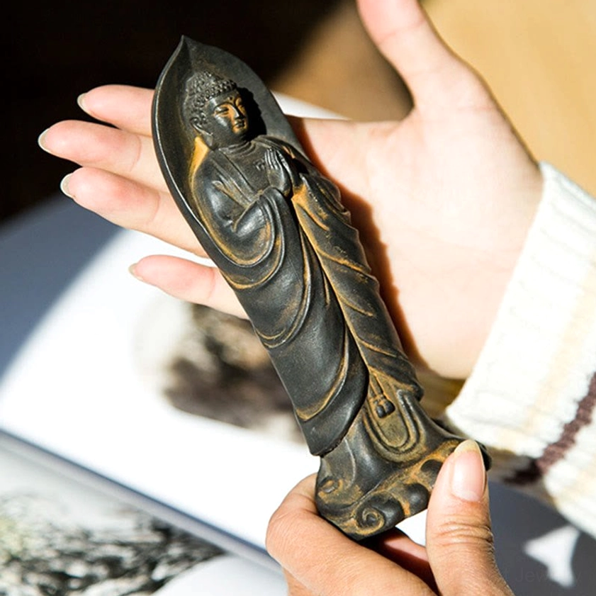 Hand-held size comparison of Sakyamuni Buddha Namaste statue, palm view showing compact dimensions for altar or desk decoration