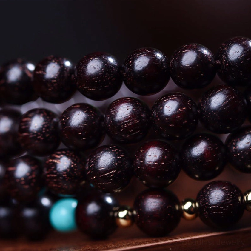 Macro photography of red sandalwood bead texture showing deep reddish-brown color and natural flecks