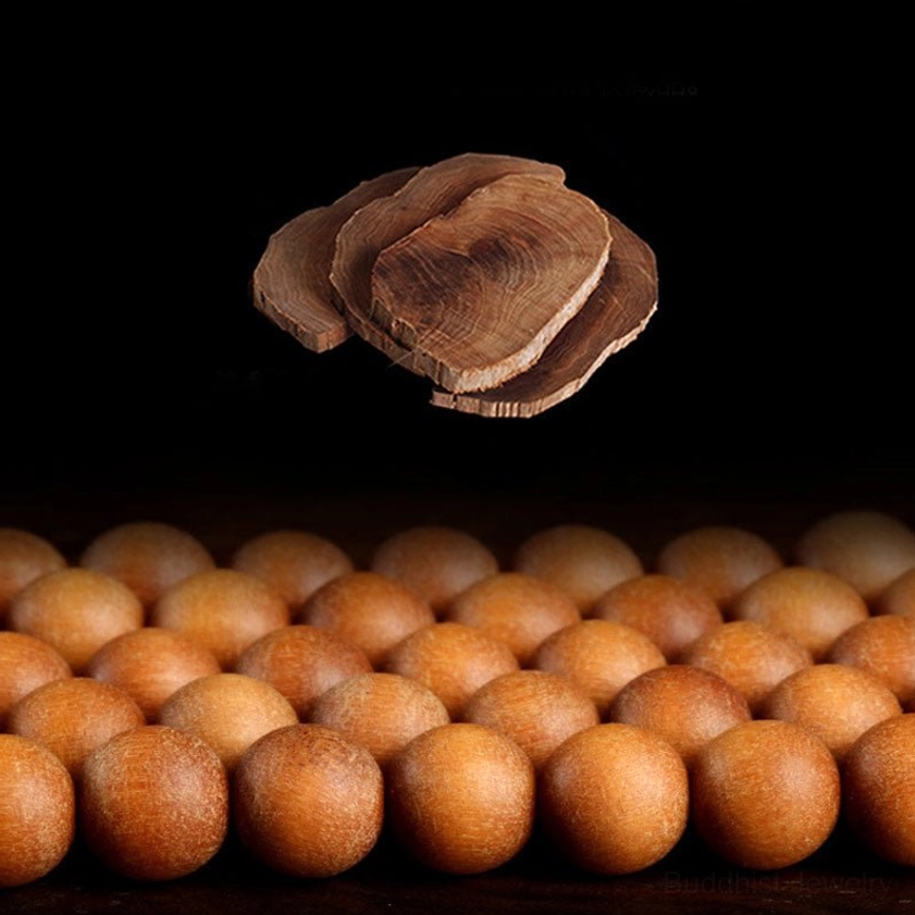 Close-up flat lay of natural sandalwood beads and sliced sandalwood wood pieces on black background, showing authentic material quality