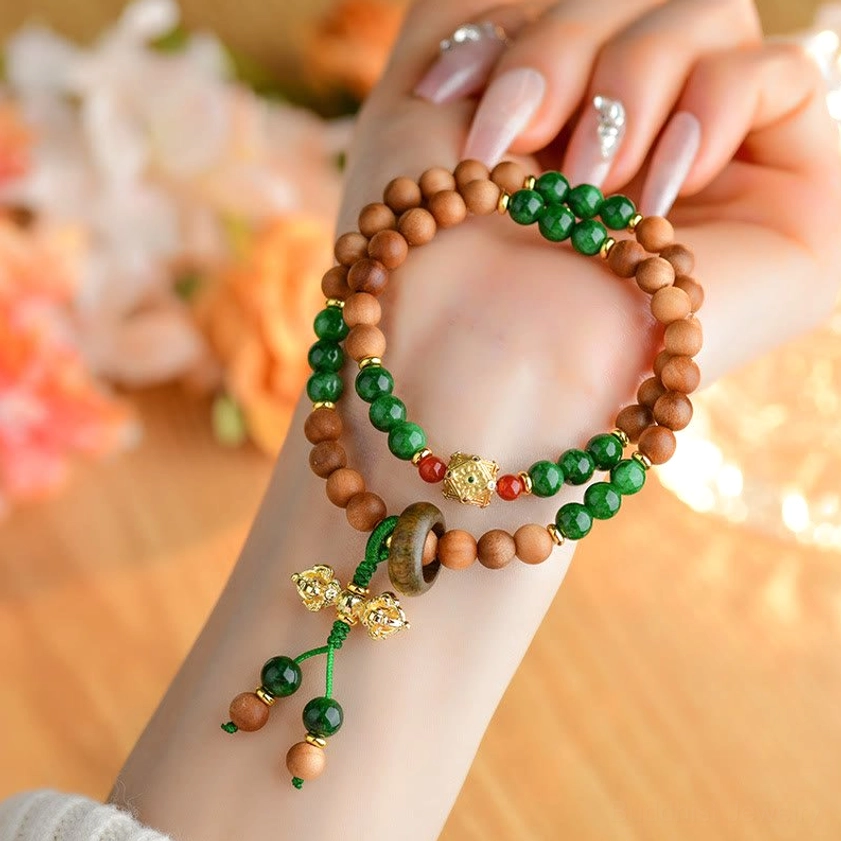 Sandalwood Dorje Vajra bracelet on wrist close-up showing comfort fit and natural wood bead texture