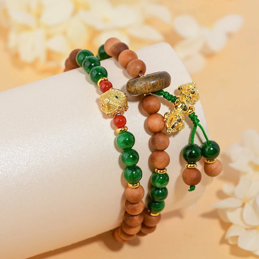 Two sandalwood Dorje Vajra bracelets with gold charms on mannequin arm showing fit and design