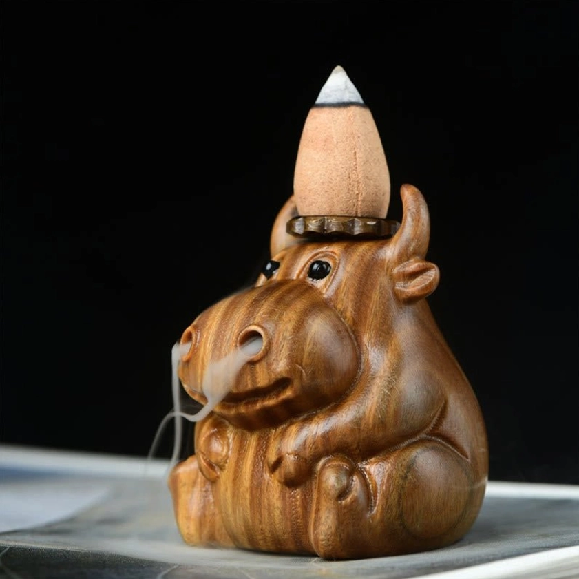 Side view of green sandalwood backflow incense burner with incense cone installed and side smoke flow