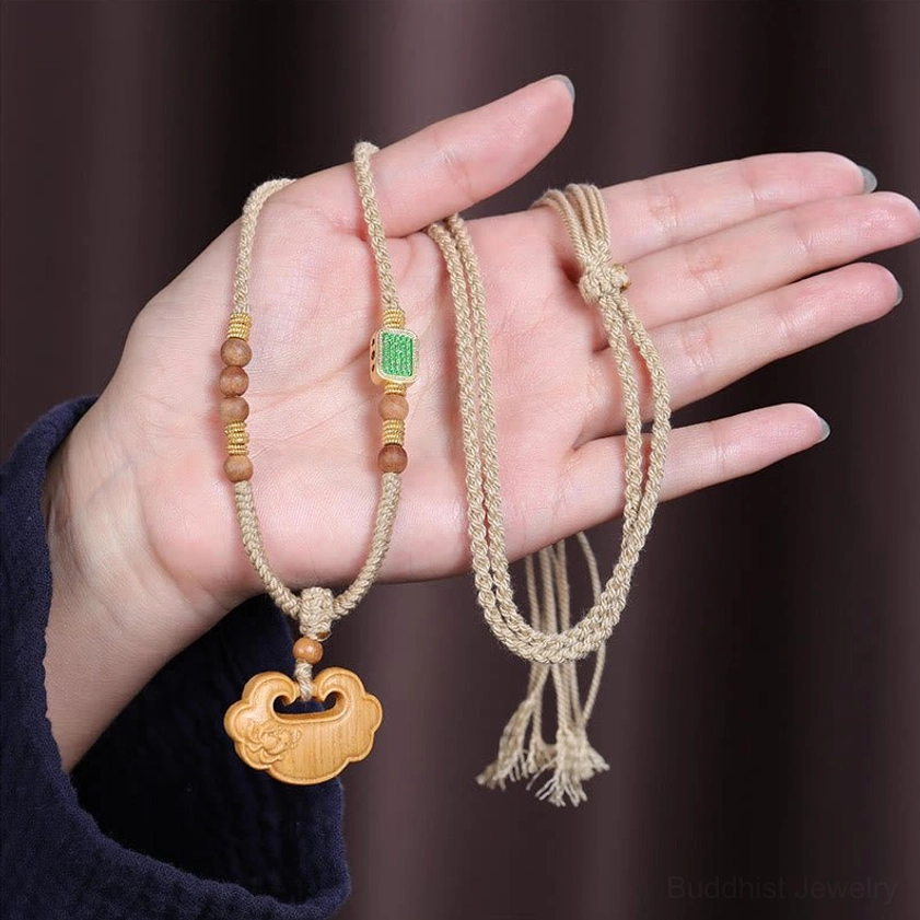 Adjustable sandalwood necklace with lock pendant held in hand, showing actual size and wearing effect
