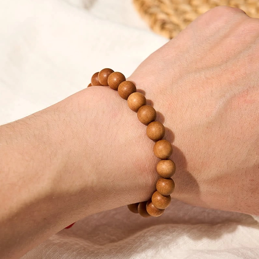 Sandalwood mala bracelet packaging and product presentation, showing craftsmanship and natural materials