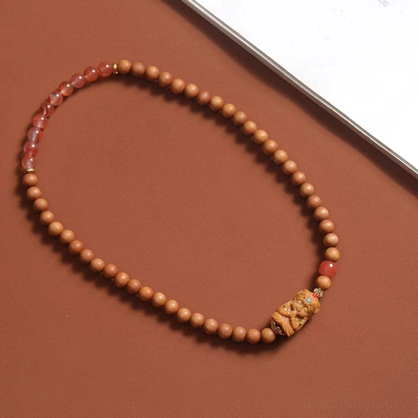 Long sandalwood prayer bead strand with tiny aromatic beads and Zakiram carved deity charm pendant