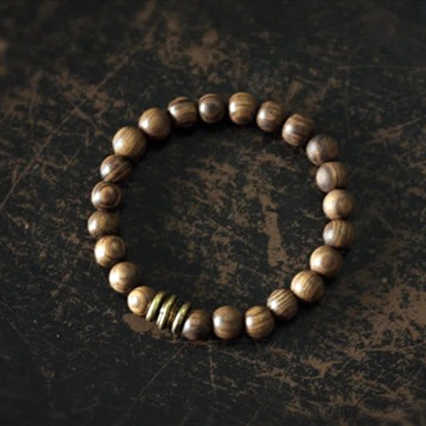 Full sandalwood prayer bracelet strand unfastened, flat lay view showing natural wood grain and complete bead arrangement