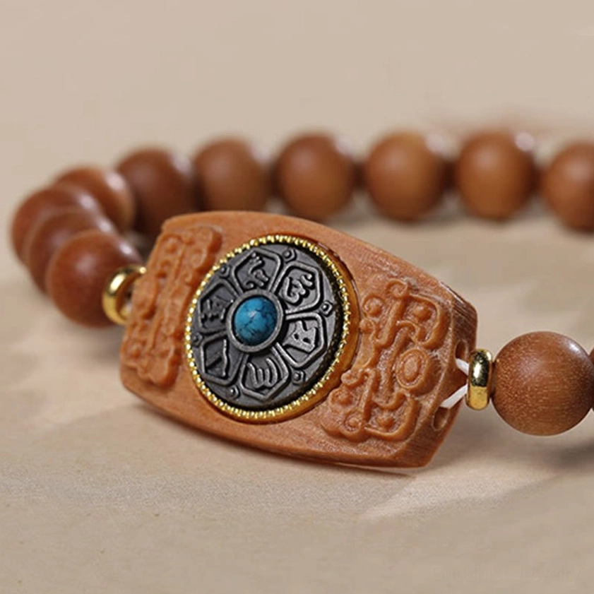 Buddhist meditation bracelet featuring sandalwood beads and om mani padme hum focal charm, lifestyle setting