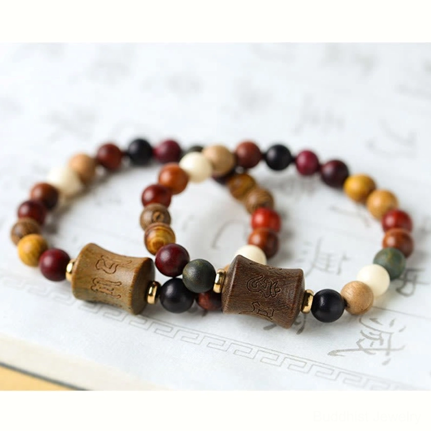 Sandalwood Om Mani Padme Hum bracelet displaying natural wood tones and spiritual mantra engraving on central bead