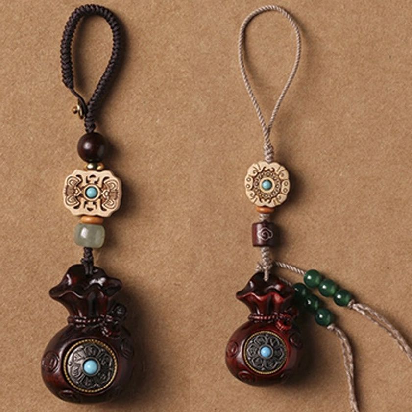 Sandalwood Om Mani Padme Hum charm with rope and beads showing complete product assembly and craftsmanship