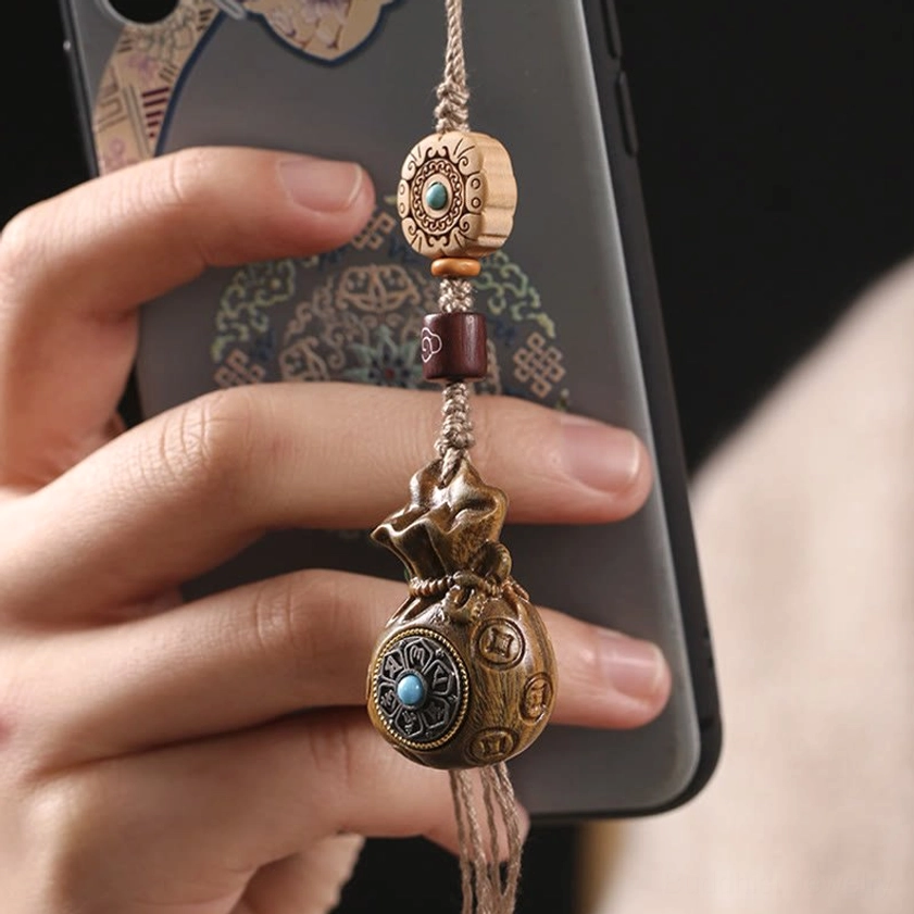 Sandalwood Om Mani Padme Hum keychain close-up showing intricate carved details and natural wood color variations