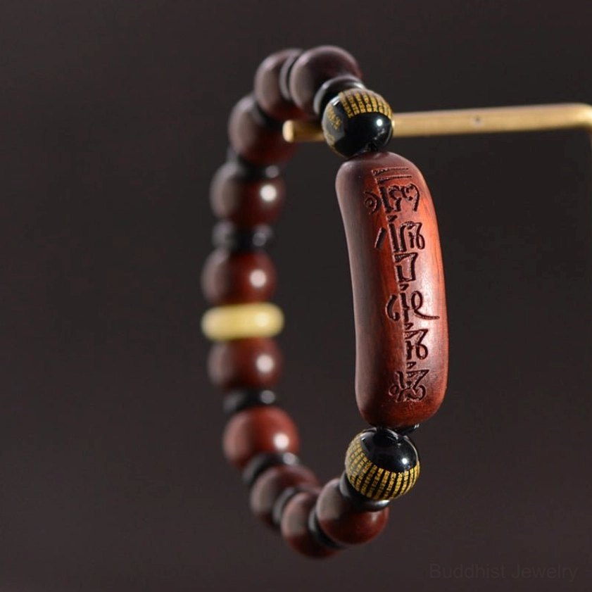 Om Mani Padme Hum sandalwood bracelet hanging display with engraved focal bead