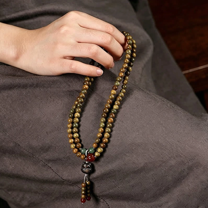 Hand-woven sandalwood prayer mala elastic cord and bead assembly detail view