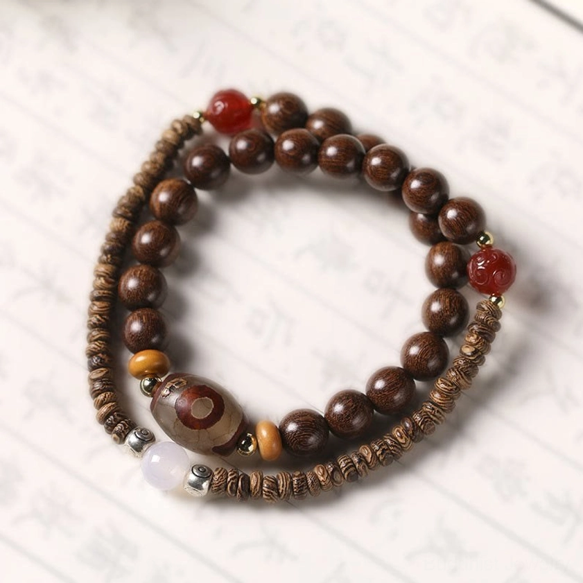 Close-up detail of sandalwood wood grain texture showing natural aromatic wood used in double wrap Buddhist meditation bracelet