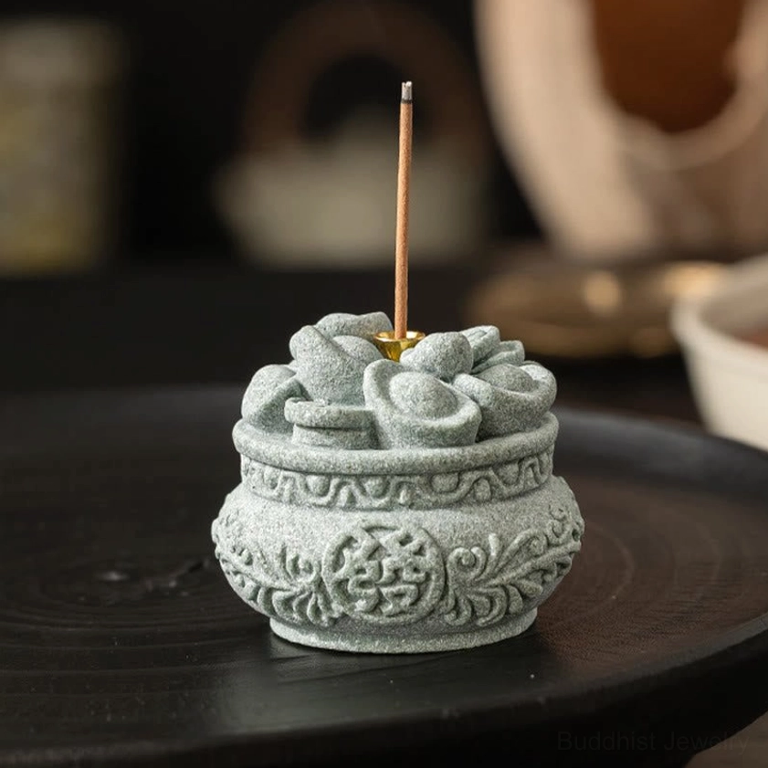 Gray sandstone incense burner with incense stick and ingot decorations on wooden serving tray