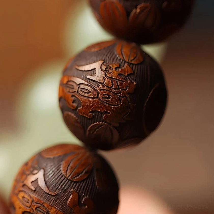Extreme close-up of polished sappan wood beads with embossed patterns on Buddhist Pixiu bracelet