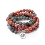 108 bead mala bracelet with sea sediment jasper stones and silver lotus pendant flat lay