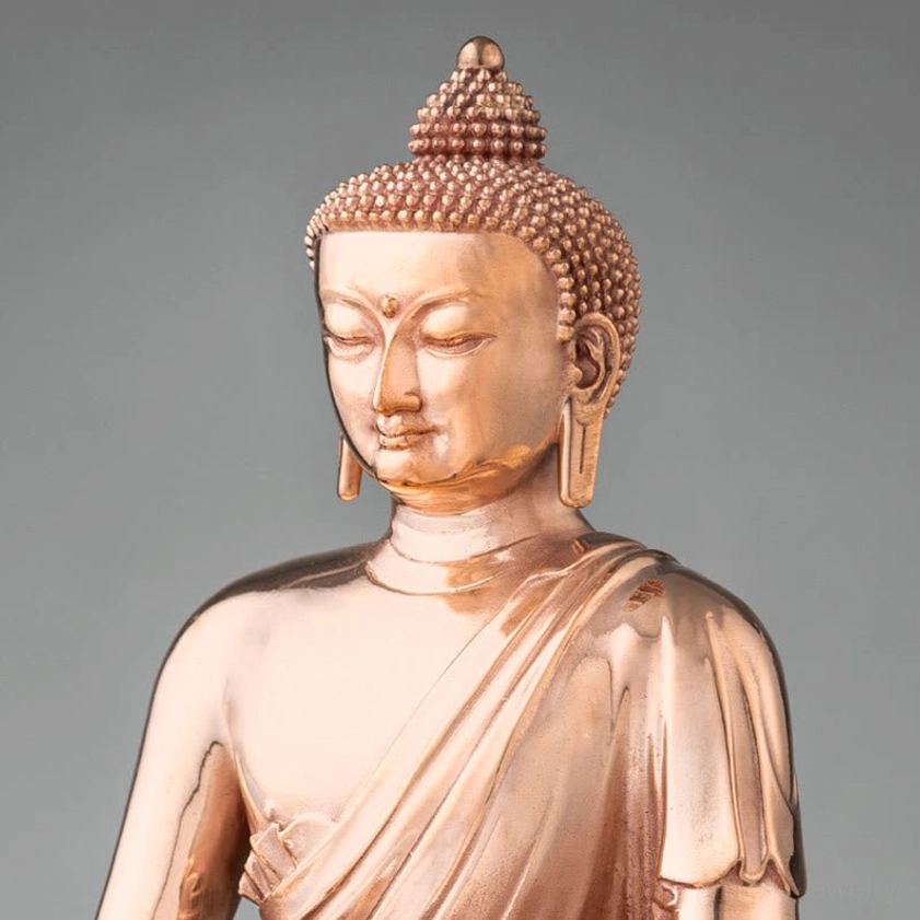 Buddha head and upper body close-up showing serene facial features and ushnisha topknot