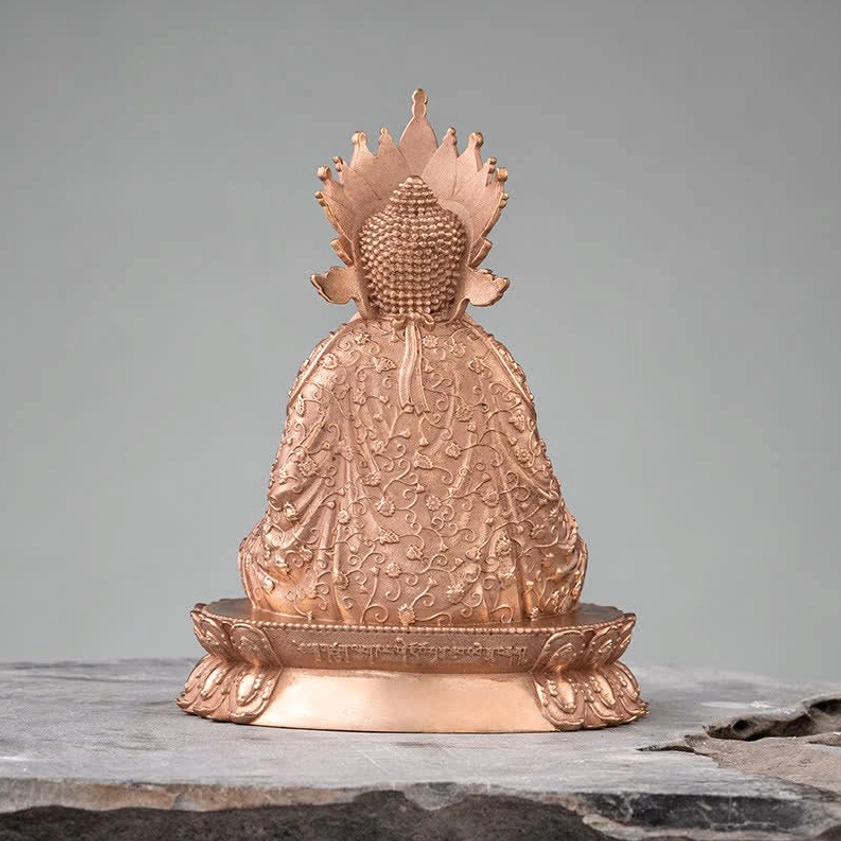 Full rear view of Shakyamuni Buddha copper statue showing elaborate back pattern carvings and engraved lotus pedestal against plain background
