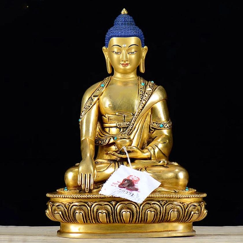 Shakyamuni Buddha copper statue rear view displaying ornate robe design and gilt bronze back with lotus pedestal