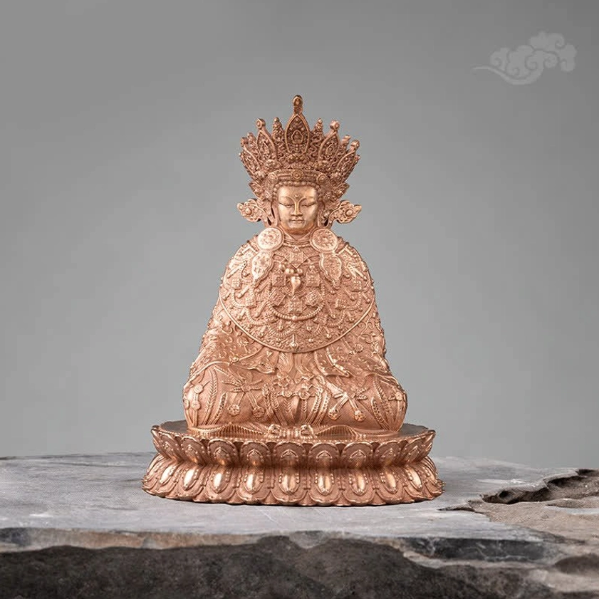 Direct frontal view of handmade copper Buddha statue with elaborate crown and detailed chest carvings on traditional lotus base