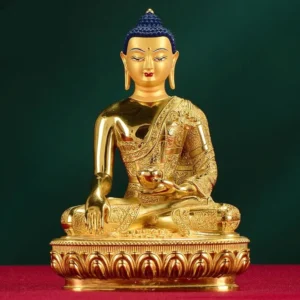 Shakyamuni Buddha copper statue frontal view with gilt finish and carved robes on lotus base