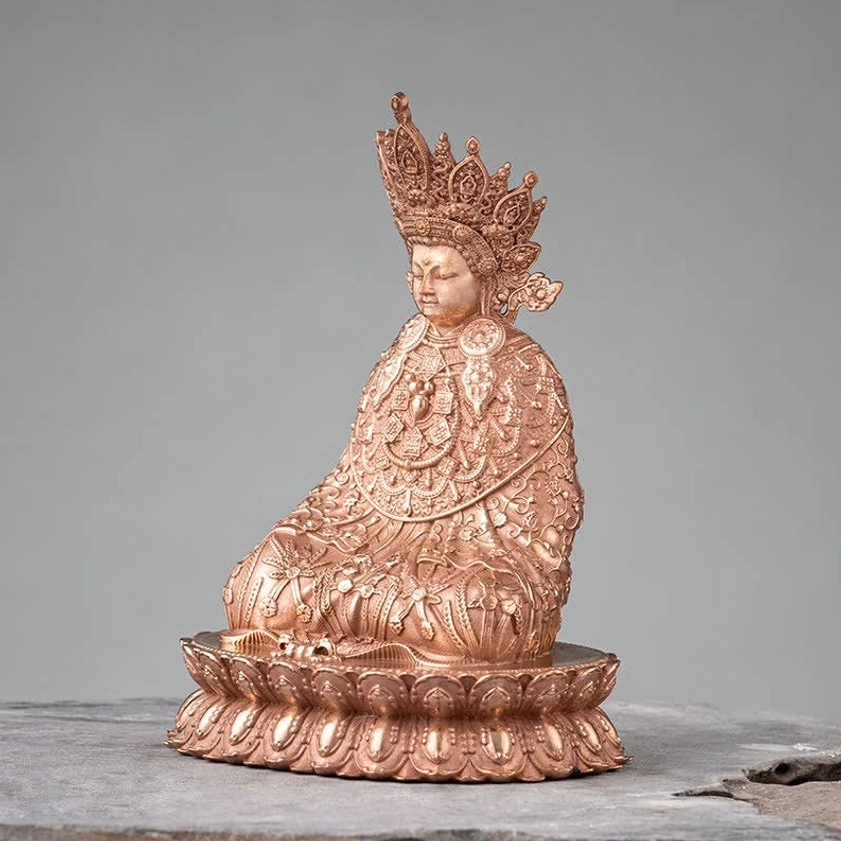 Left side perspective of Shakyamuni Buddha copper figurine showing tall carved crown and flowing draped robes with ornate patterns