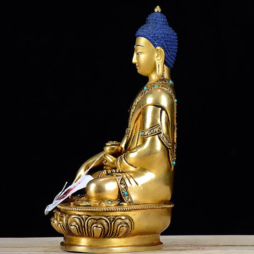 Shakyamuni Buddha statue right side profile showing turquoise stone inlays in robe trim and detailed copper craftsmanship