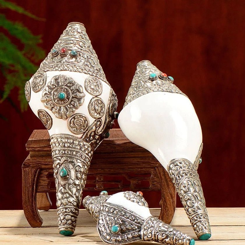 Multiple handcrafted Buddhist shankha conch decorations in various sizes showing vintage silver filigree details and gemstone inlays