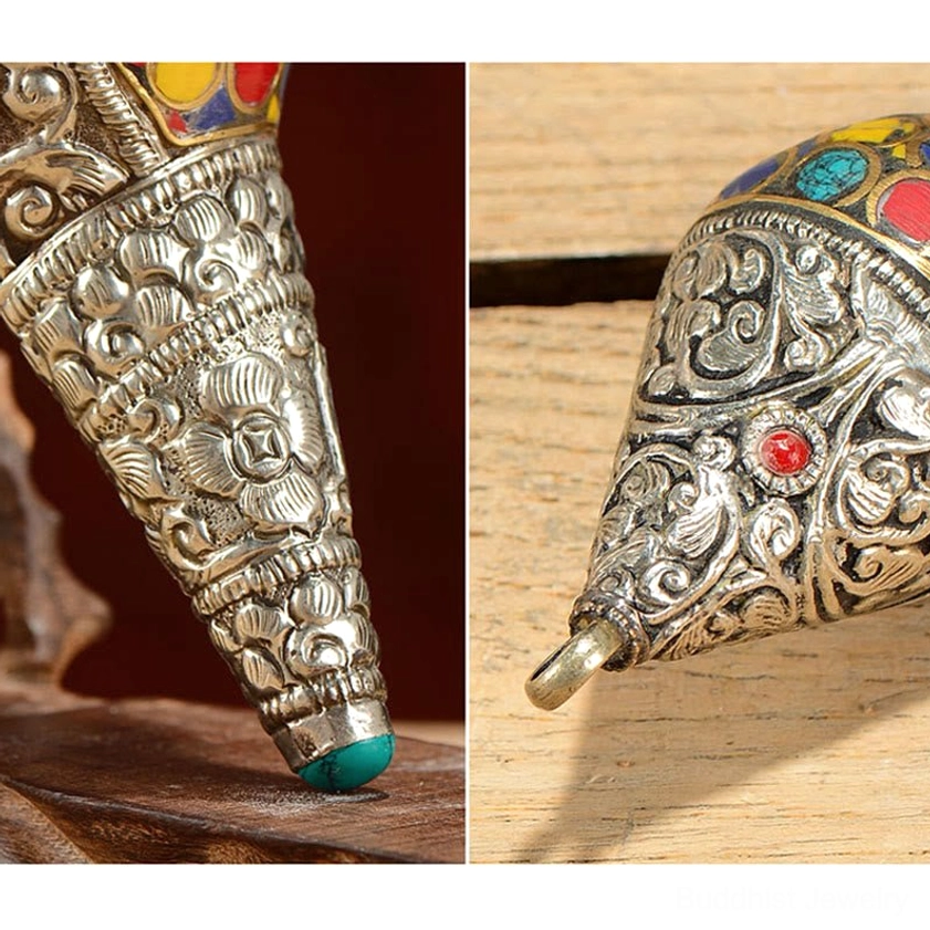 Close-up macro detail of shankha conch shell metal tip with floral carved silver design and turquoise end cap