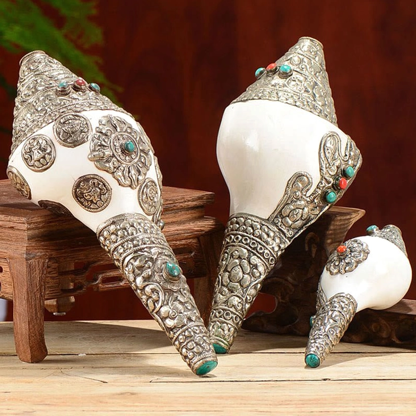 Tibetan silver-inlaid shankha conch shell home decoration with turquoise and red gemstone accents displayed on wooden stand