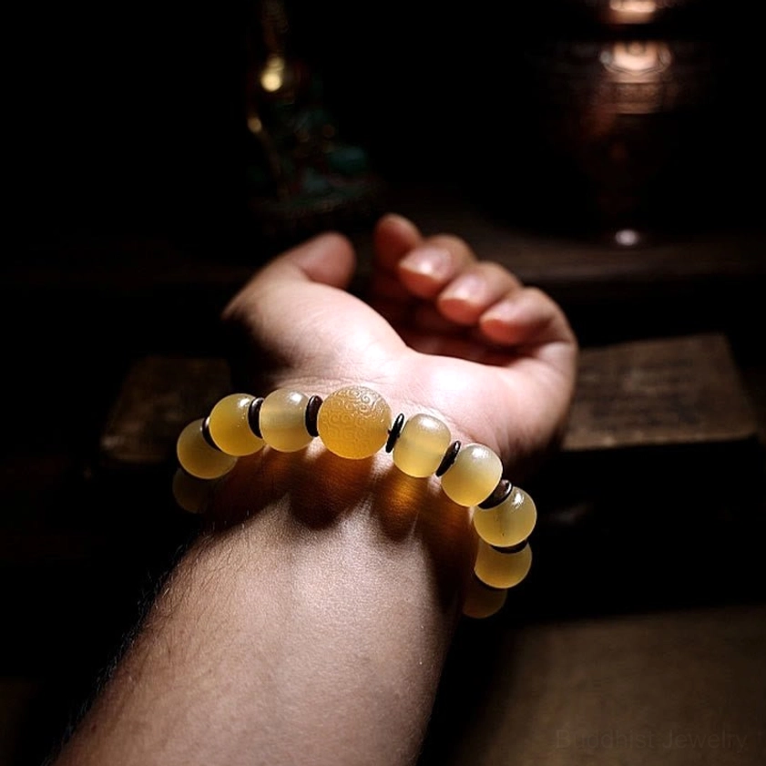 Handmade Buddhist sheep horn bracelet with sacred Om Mani mantra symbolism, wearable spiritual protection talisman