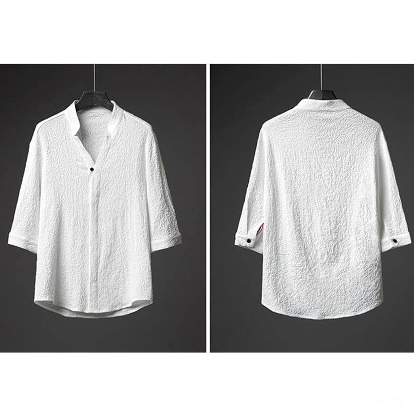 Detail view of textured white shirt hem showing curved uneven edge and wrinkled fabric construction