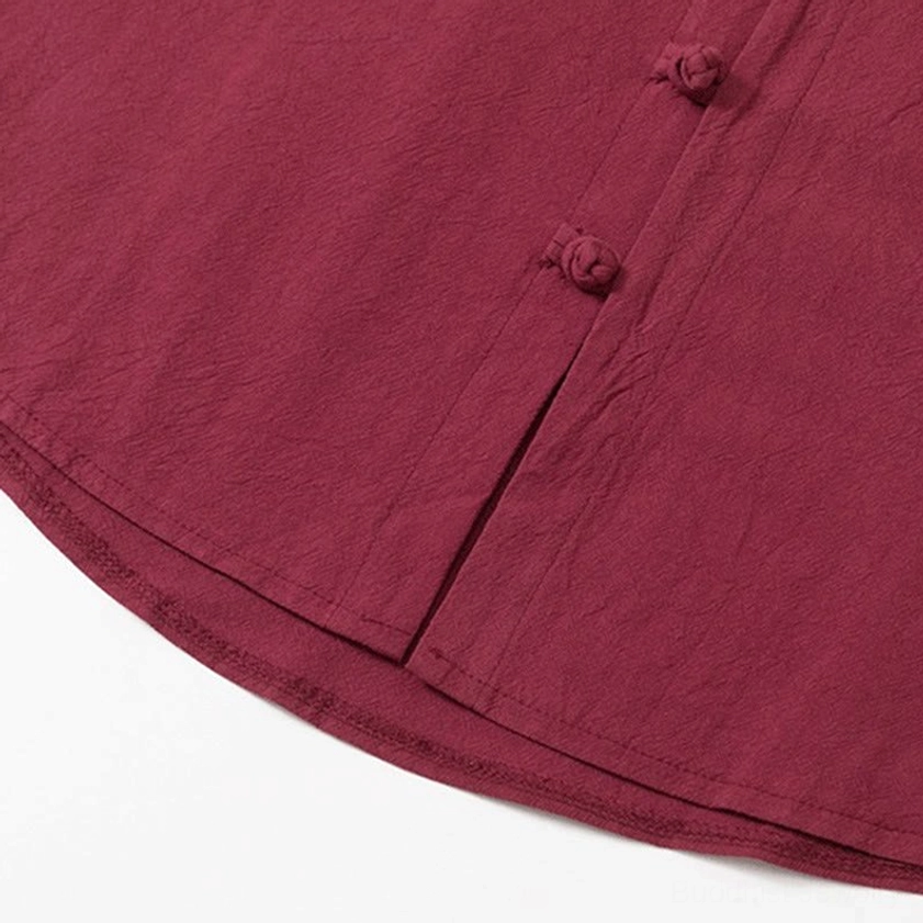 Shirt hem and front button placket detail on Buddhist meditation garment, burgundy color