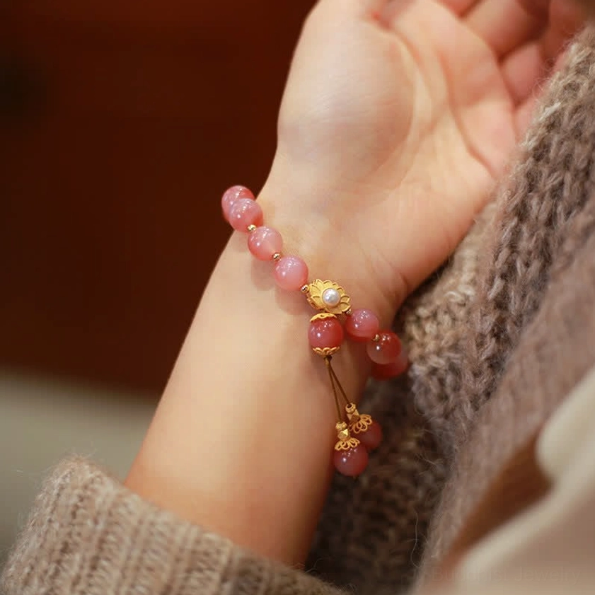 Lotus agate bracelet worn on wrist side view with gold-plated charm and tassel pendant