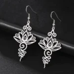 Silver hollow lotus flower drop earrings flat lay with intricate filigree design, Buddhist enlightenment jewelry