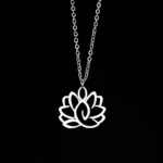 Hollow lotus enlightenment necklace in silver stainless steel, front top-down view on black background showcasing the carved lotus pendant design