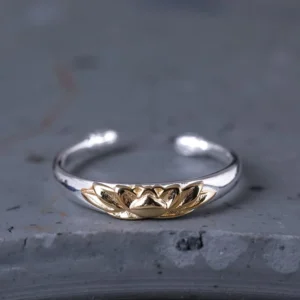 925 sterling silver lotus flower open cuff ring with embossed gold lotus motif front view on grey stone
